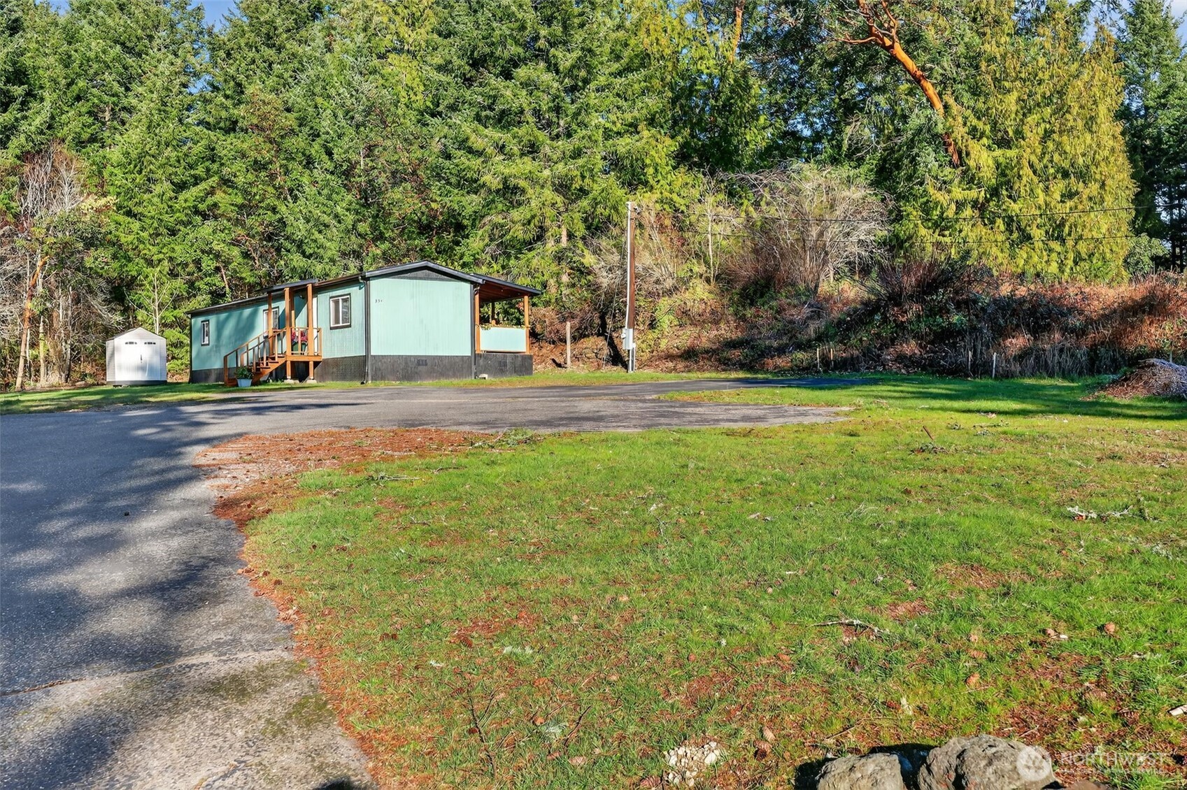 15503 Cedar Park Road Southeast, Unit 35C Olalla, WA 98359 - Photo 1 of 23 a front view of a house with a yard and garage
