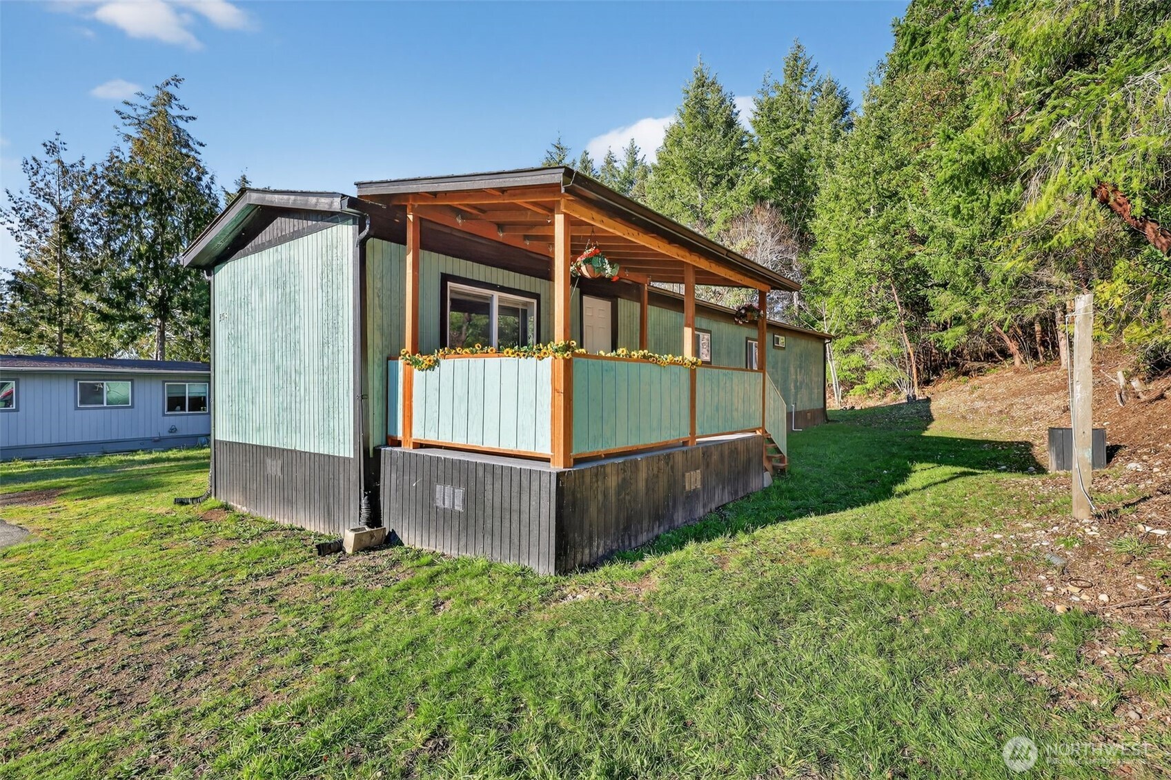15503 Cedar Park Road Southeast, Unit 35C Olalla, WA 98359 - Photo 20 of 23 a view of backyard with small cabin and wooden fence