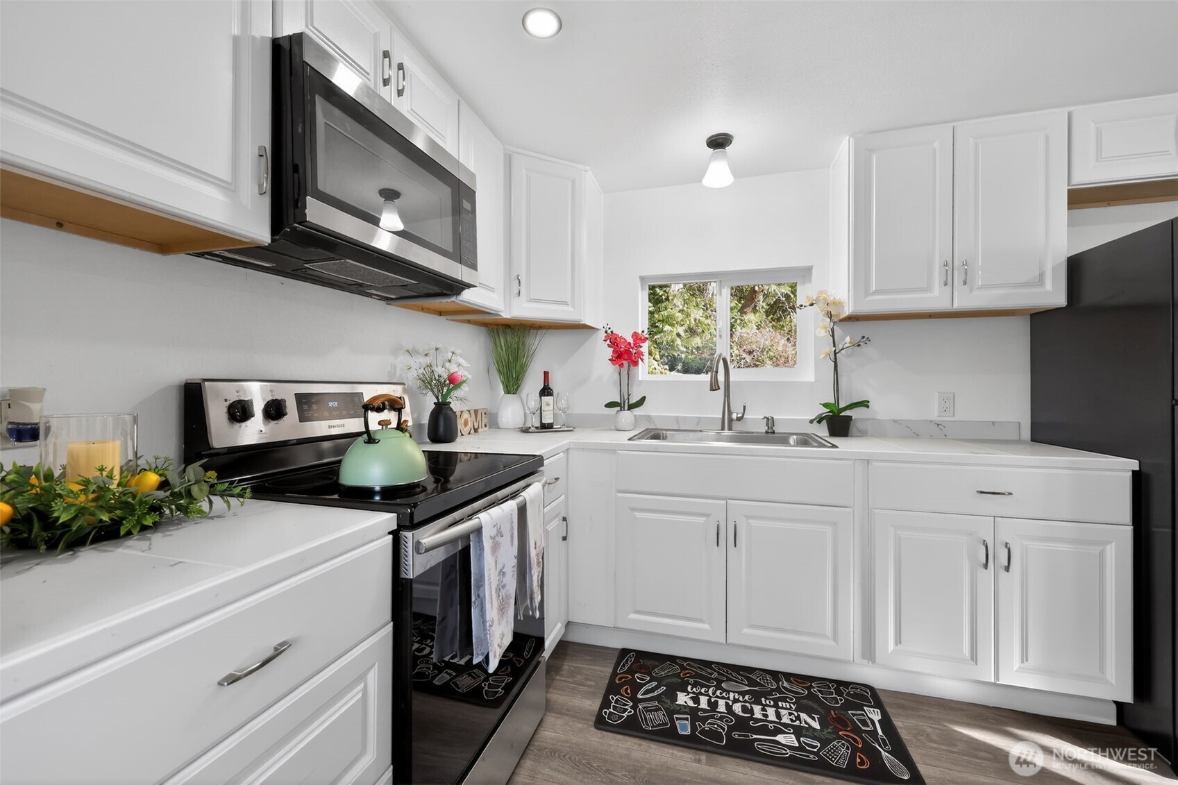 15503 Cedar Park Road Southeast, Unit 35C Olalla, WA 98359 - Photo 5 of 23 a kitchen with stainless steel appliances white cabinets and a stove top oven