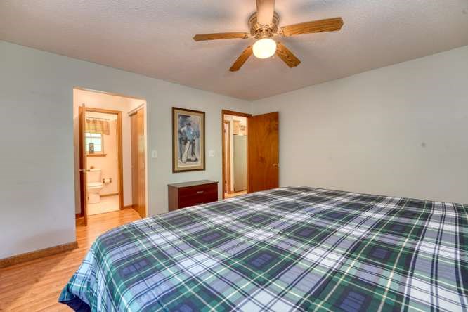 3333 Ellington Road Hayesville, NC 28904 - Photo 41 of 56 a bedroom with a large bed and a chandelier