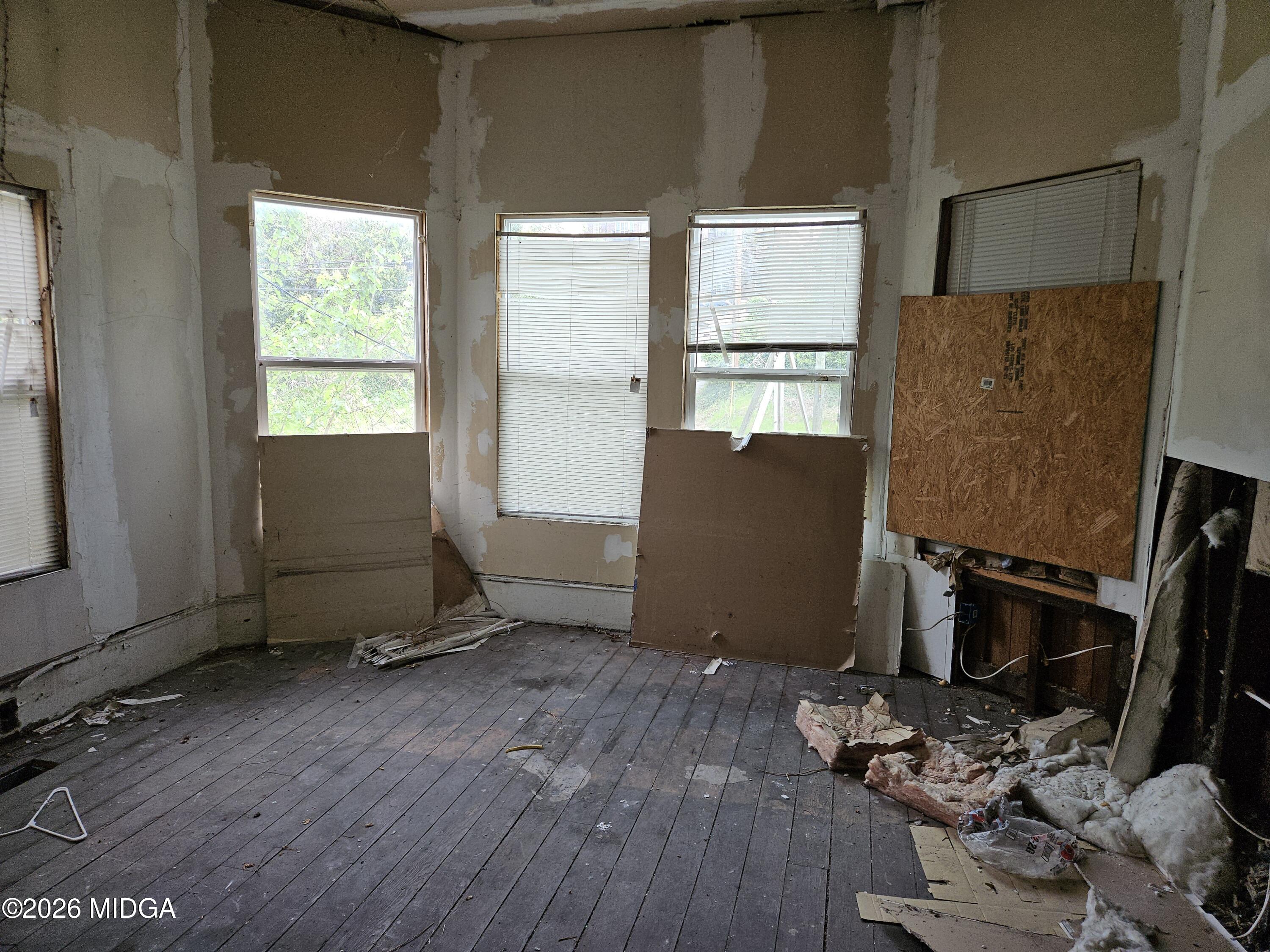 353 Madison Street Macon, GA 31201 - Photo 6 of 8 a room with wooden floor and windows