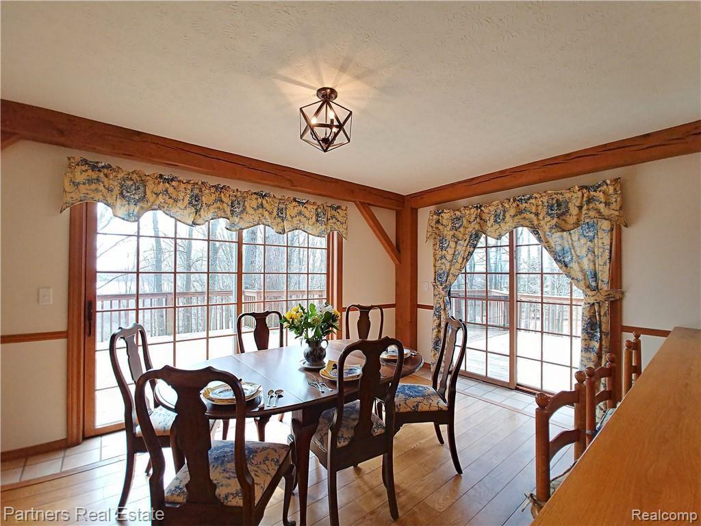 2715 West Coon Lake Road Howell, MI 48843 - Photo 12 of 54 4c. Two Sets of Sliding French Doors off Dining Area lead to Fabulous Deck