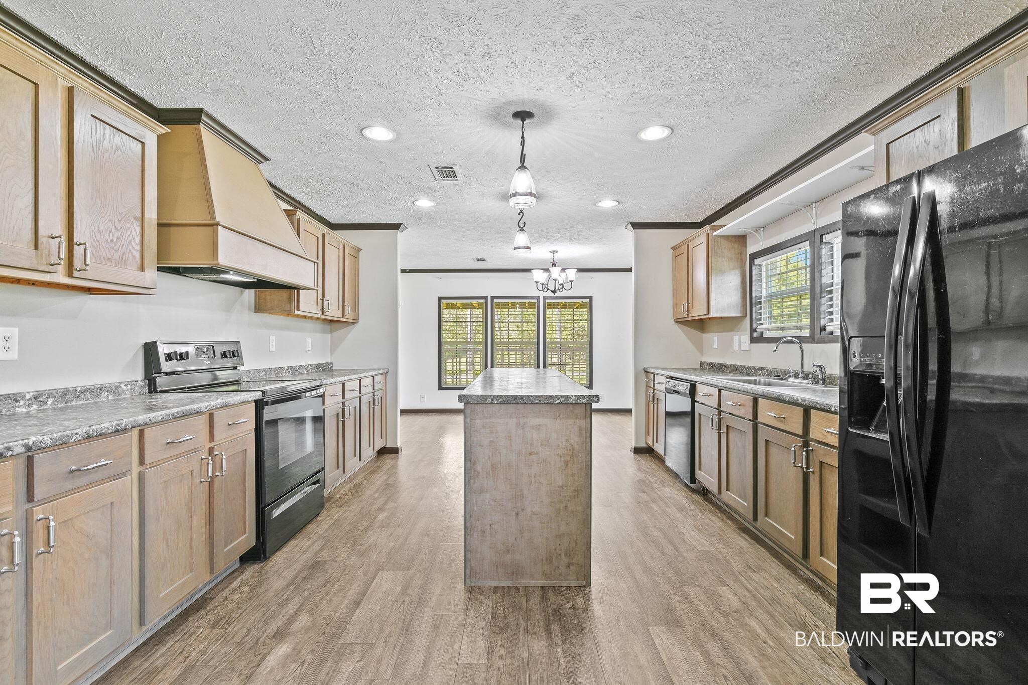 35641 County Road 39 Stapleton, AL 36578 - Photo 14 of 46 Kitchen featuring a kitchen island, appliances with stainless steel finishes, custom range hood, and a wealth of natural light