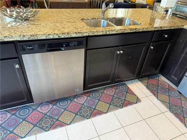 a kitchen with stainless steel appliances granite countertop a refrigerator stove and microwave