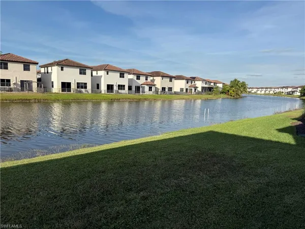 a view of a water pond with green field