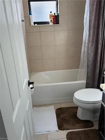 a bathroom with a granite countertop sink a mirror and shower