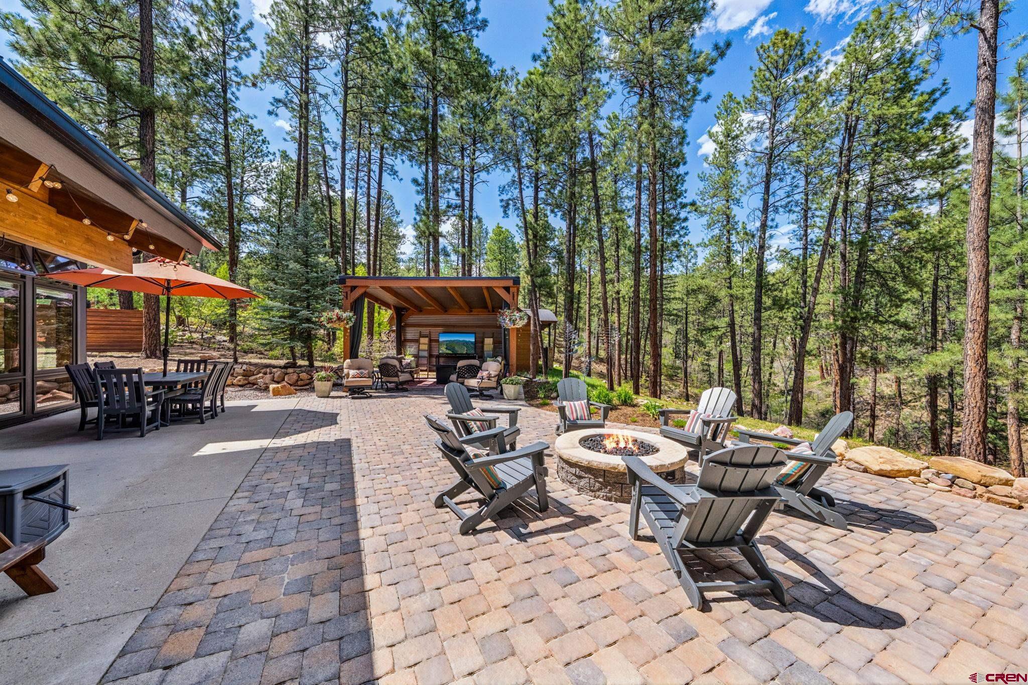 24 Monarch Crest Trail Durango, CO 81301 - Photo 8 of 45 a view of a patio with a table and chairs under an umbrella