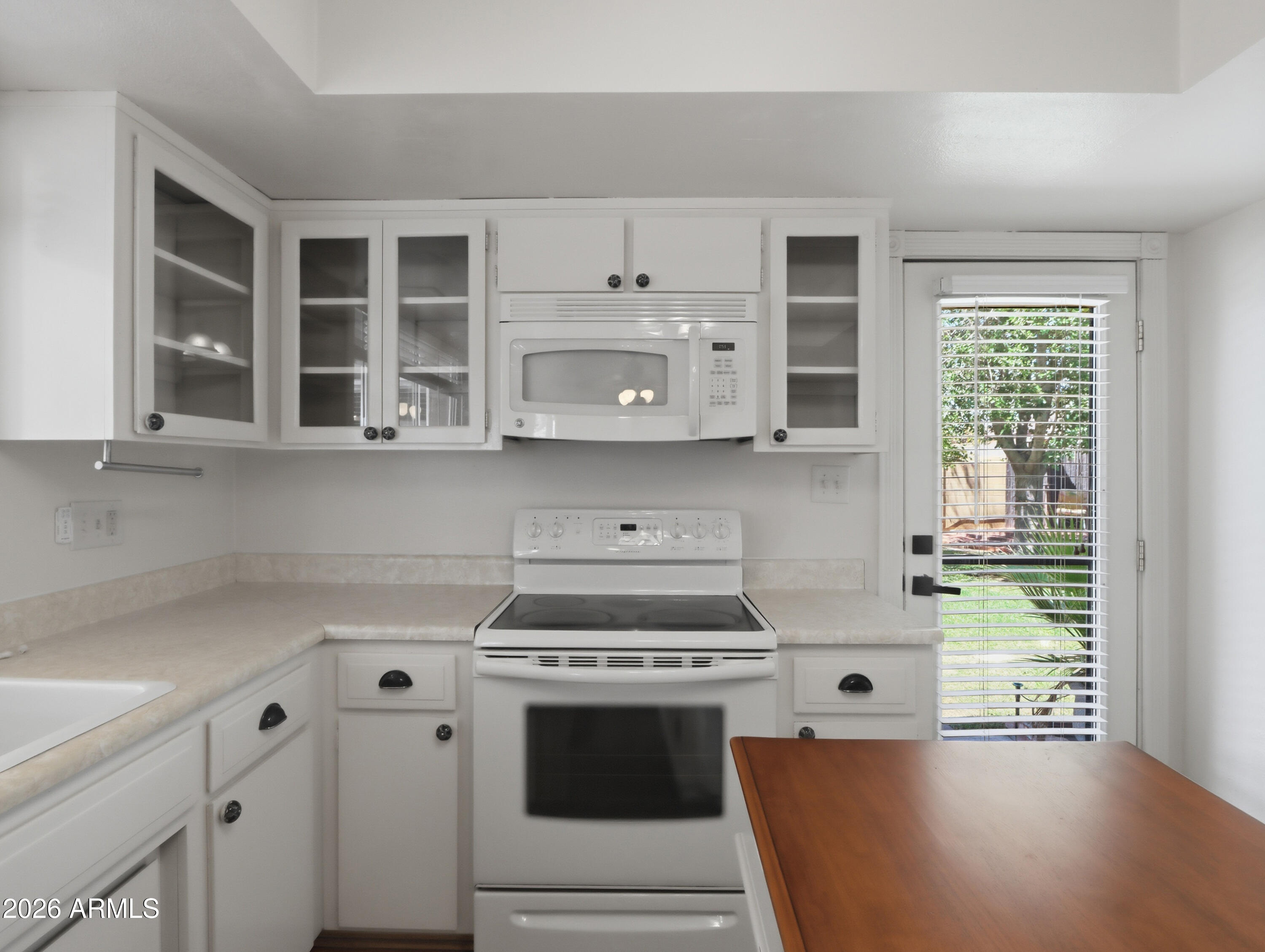 450 Cascada Road Litchfield Park, AZ 85340 - Photo 14 of 40 a kitchen with stainless steel appliances white cabinets and a stove top oven