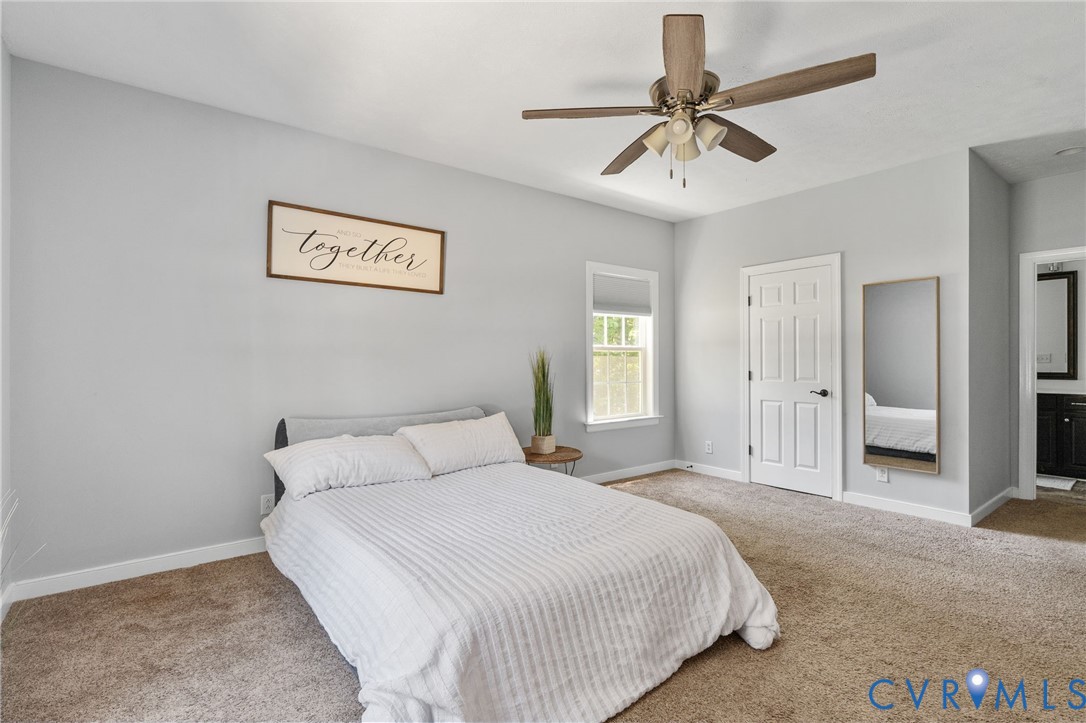 1755 Dispatch Road Quinton, VA 23141 - Photo 37 of 86 a bedroom with a bed and a chandelier
