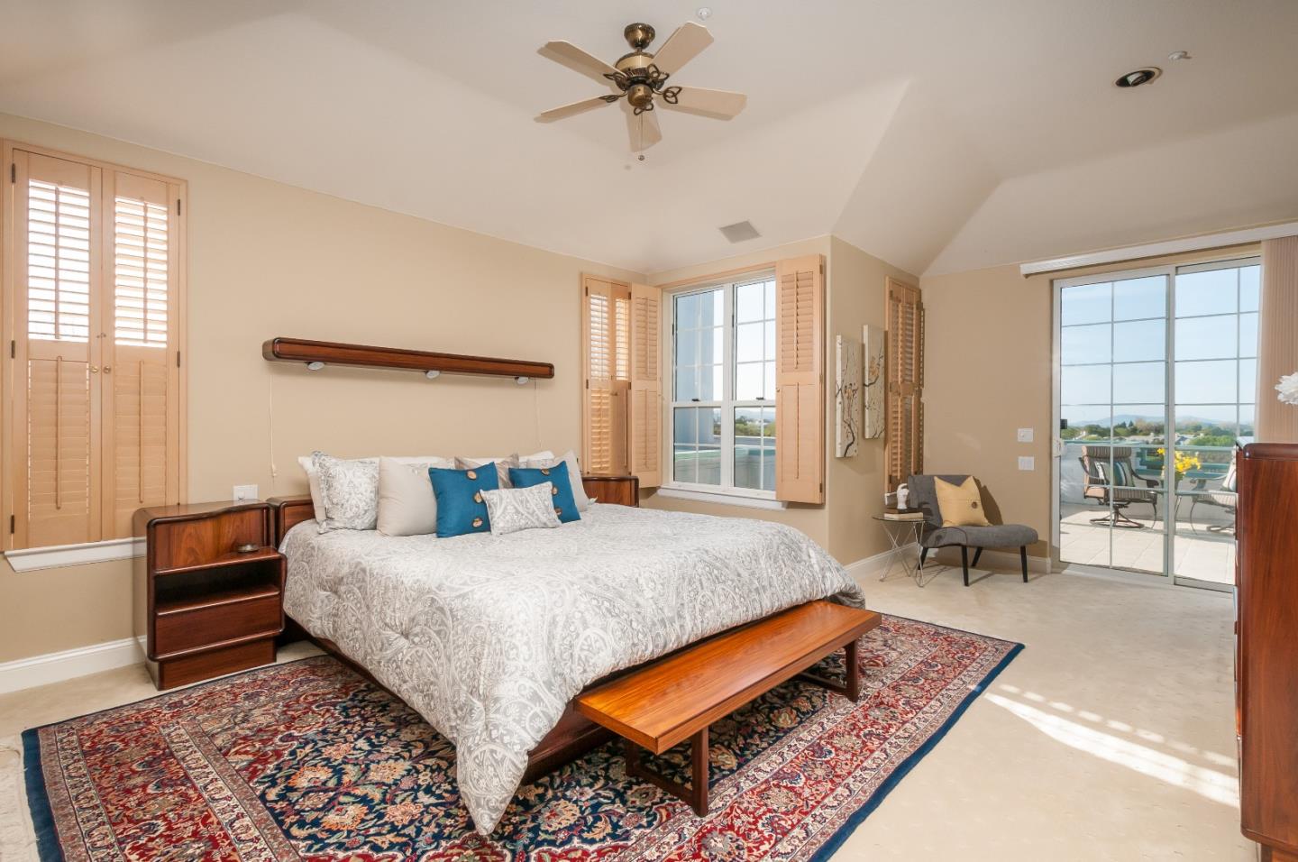 720 Promontory Point Lane, Unit 2402 Foster City, CA 94404 - Photo 11 of 24 a bedroom with a bed a chandelier and a window
