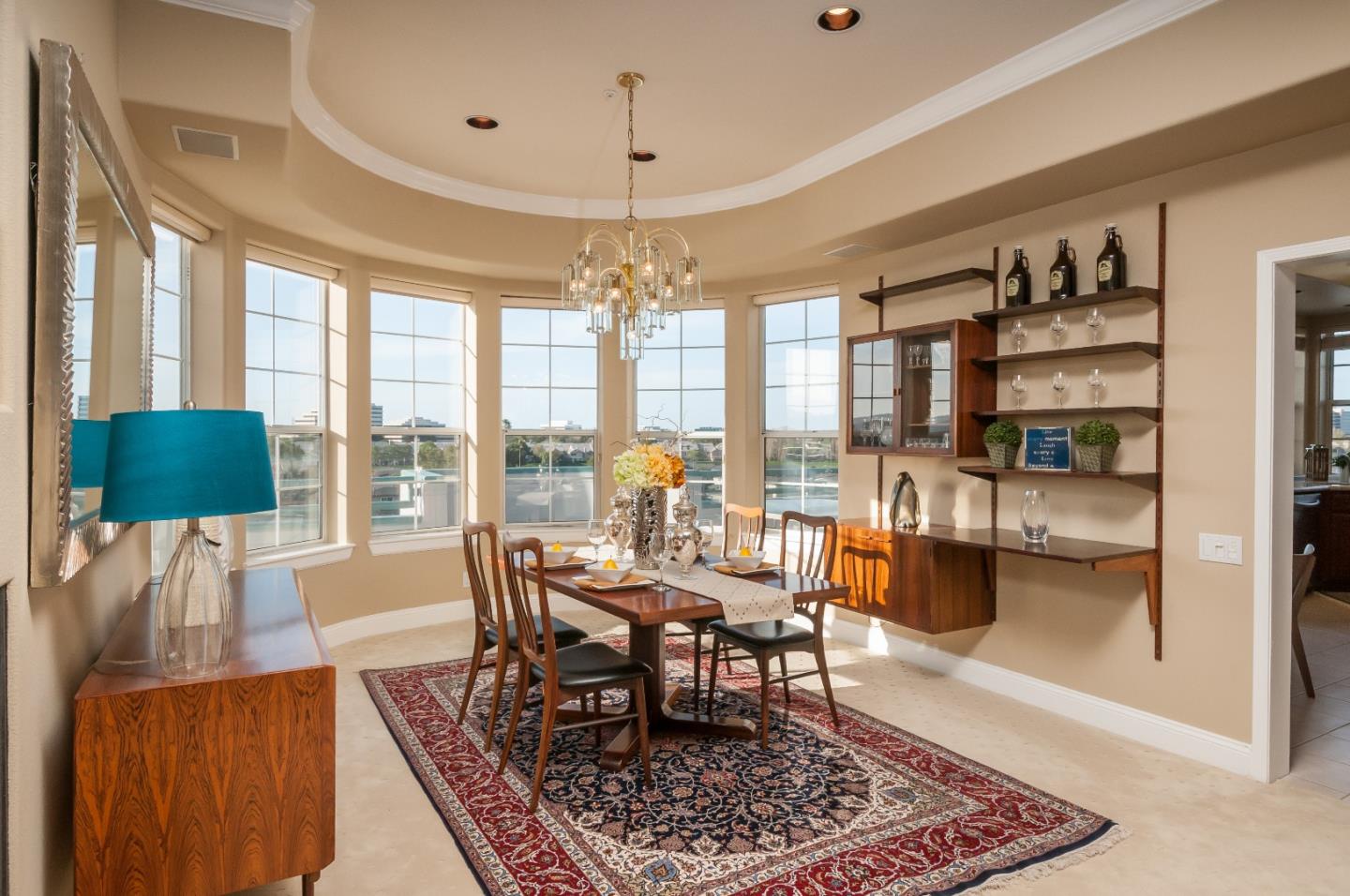 720 Promontory Point Lane, Unit 2402 Foster City, CA 94404 - Photo 8 of 24 a dining room with furniture a rug and a chandelier