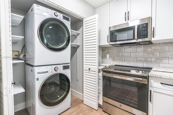 a kitchen with stove a washer and dryer