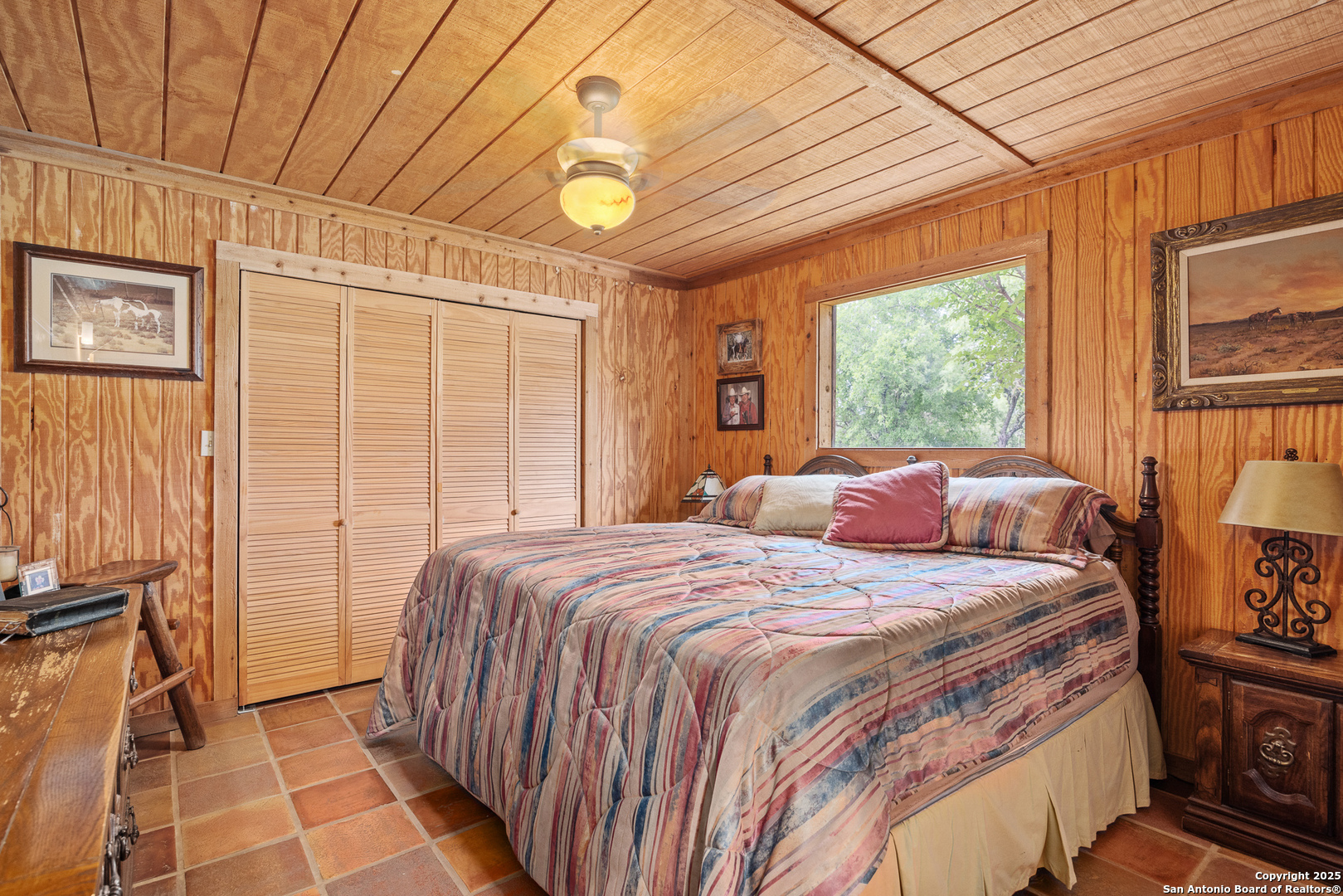 1897 Kyle Ranch Road Bandera, TX 78003 - Photo 11 of 48 a bedroom with a bed and wooden floor