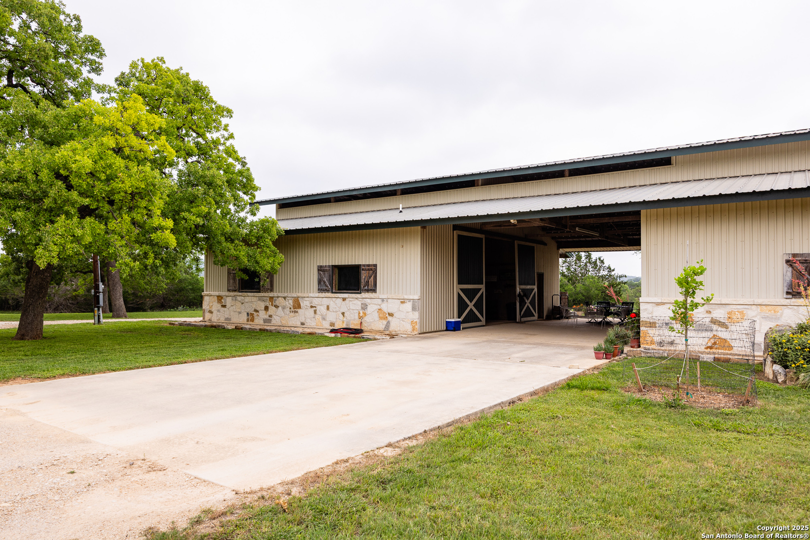1897 Kyle Ranch Road Bandera, TX 78003 - Photo 14 of 48 a front view of a house with a yard and porch