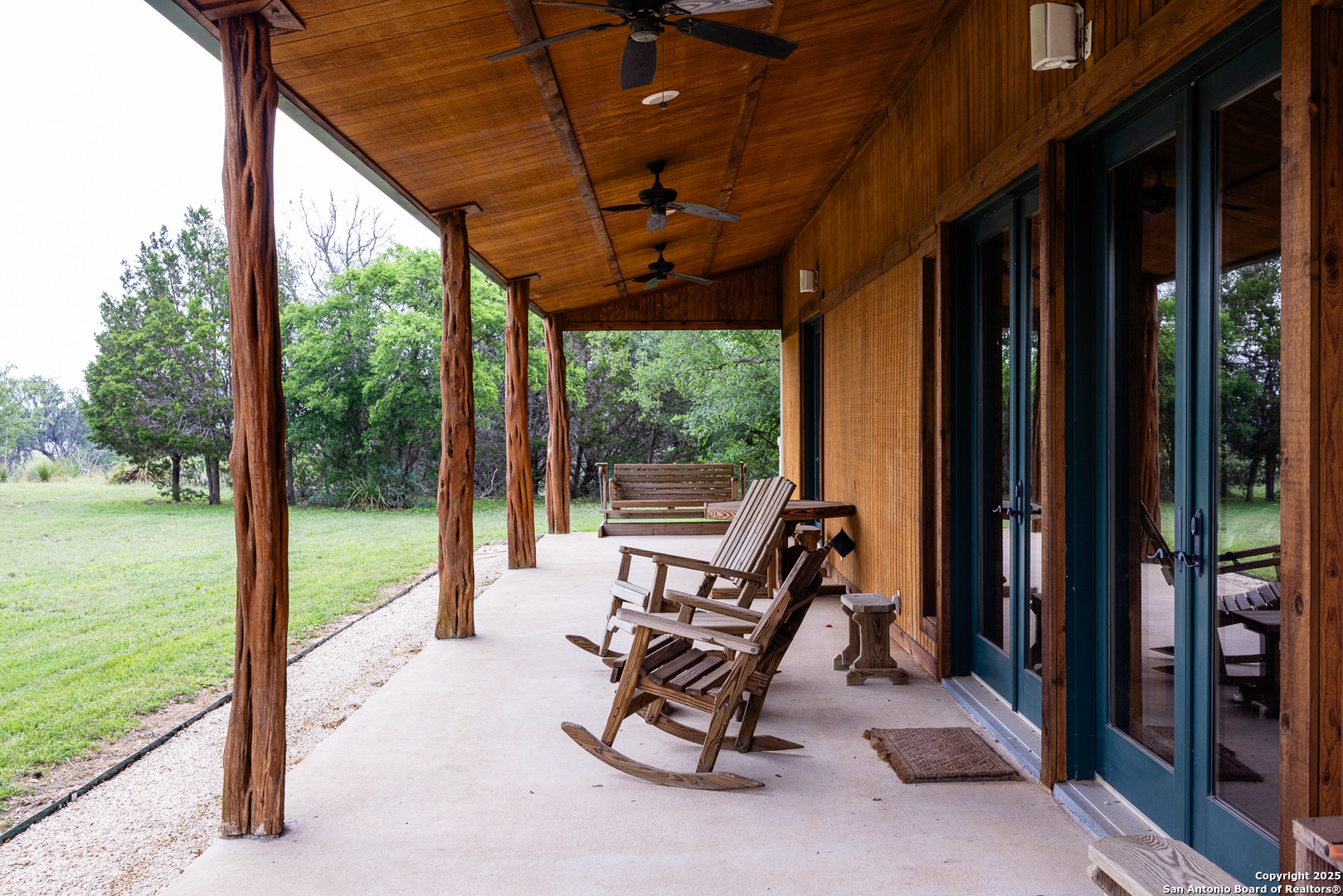 1897 Kyle Ranch Road Bandera, TX 78003 - Photo 18 of 48 a view of a room with balcony furniture and floor to ceiling window