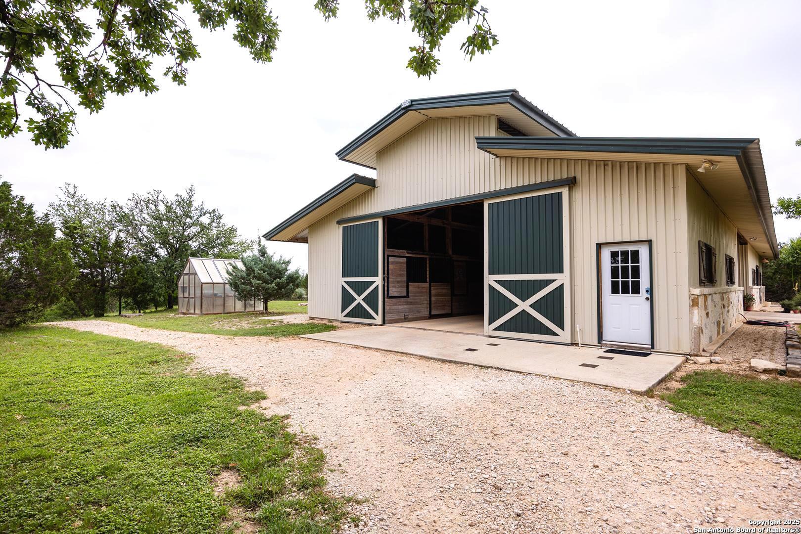 1897 Kyle Ranch Road Bandera, TX 78003 - Photo 22 of 48 a view of a house with backyard and trees