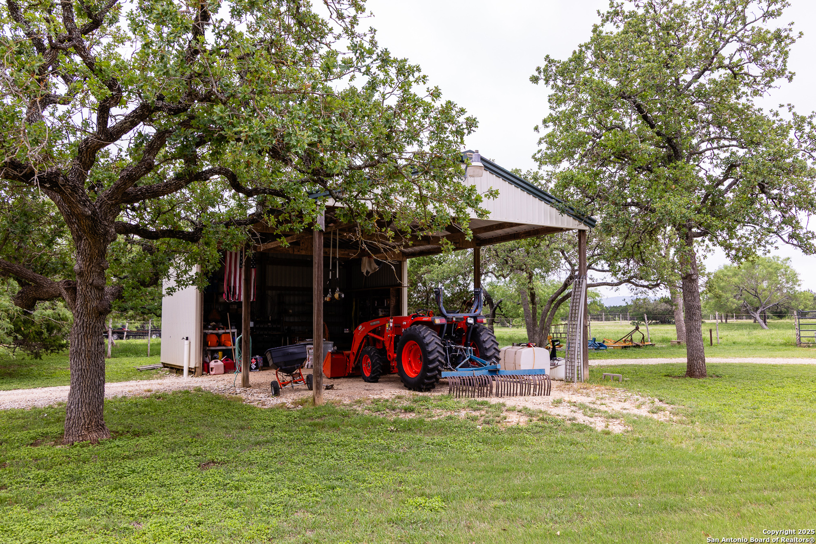 1897 Kyle Ranch Road Bandera, TX 78003 - Photo 25 of 48 a view of a park with large trees and a barn