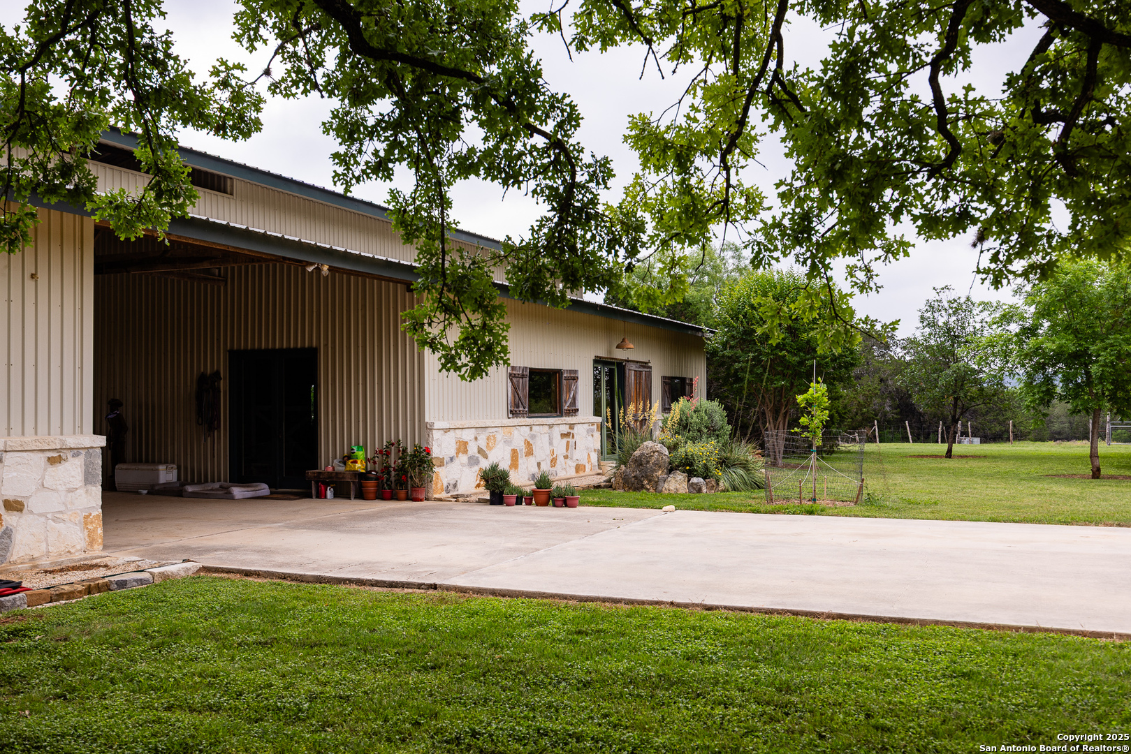 1897 Kyle Ranch Road Bandera, TX 78003 - Photo 28 of 48 a front view of a house with a yard