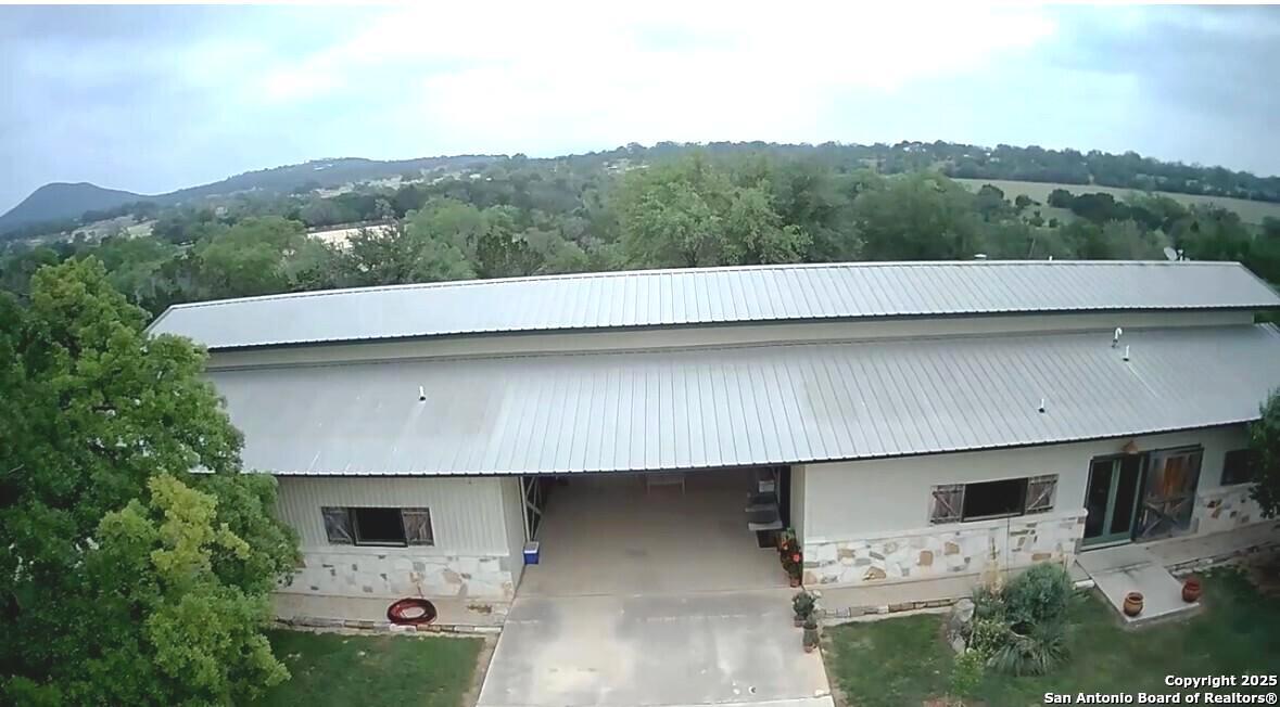 1897 Kyle Ranch Road Bandera, TX 78003 - Photo 48 of 48 an aerial view of a house with a yard