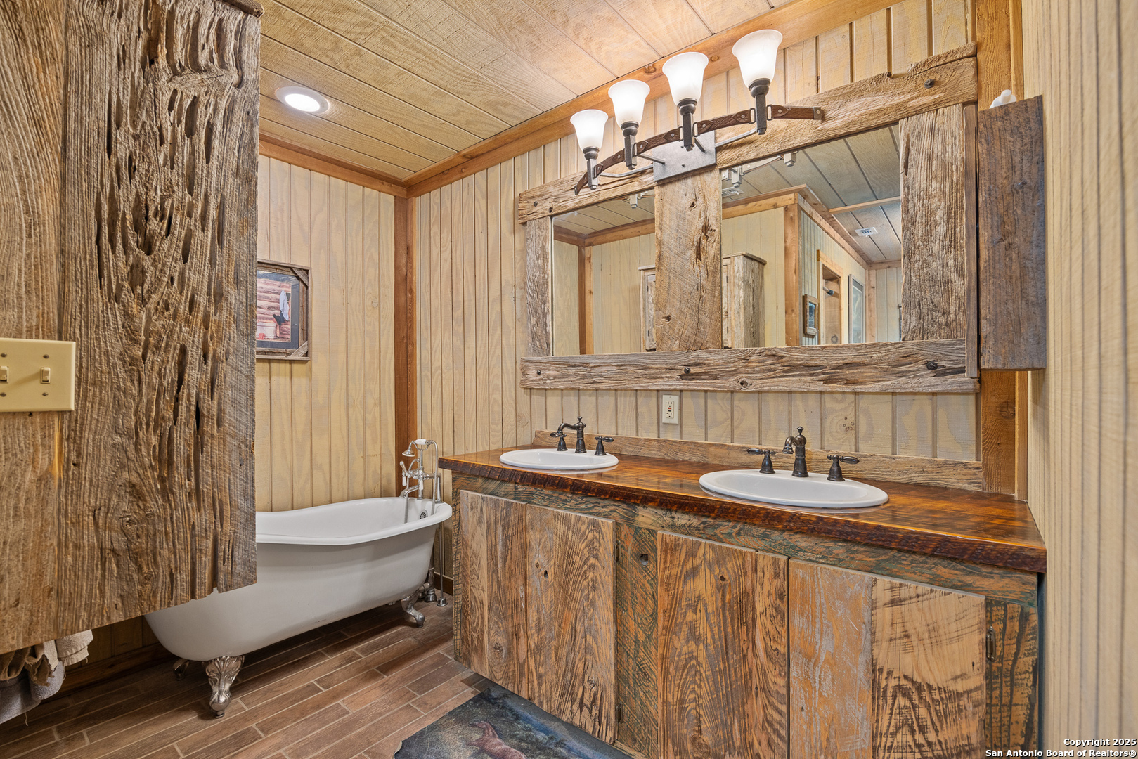 1897 Kyle Ranch Road Bandera, TX 78003 - Photo 6 of 48 a bathroom with a granite countertop sink and a mirror