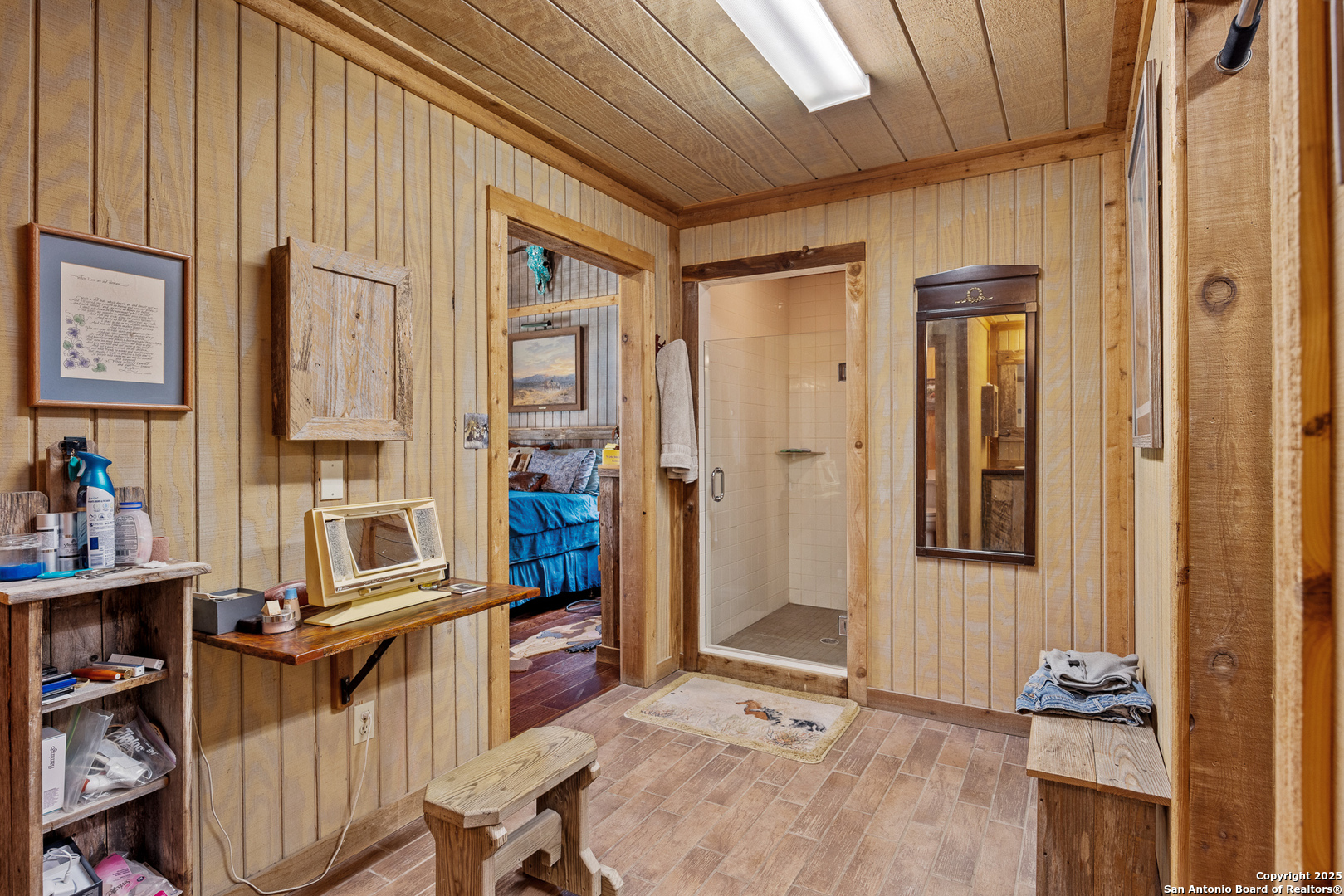 1897 Kyle Ranch Road Bandera, TX 78003 - Photo 7 of 48 a view of a bedroom with wooden floor and furniture