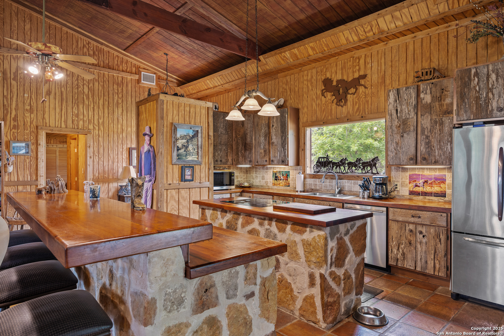 1897 Kyle Ranch Road Bandera, TX 78003 - Photo 8 of 48 a kitchen with stainless steel appliances granite countertop a sink stove and refrigerator