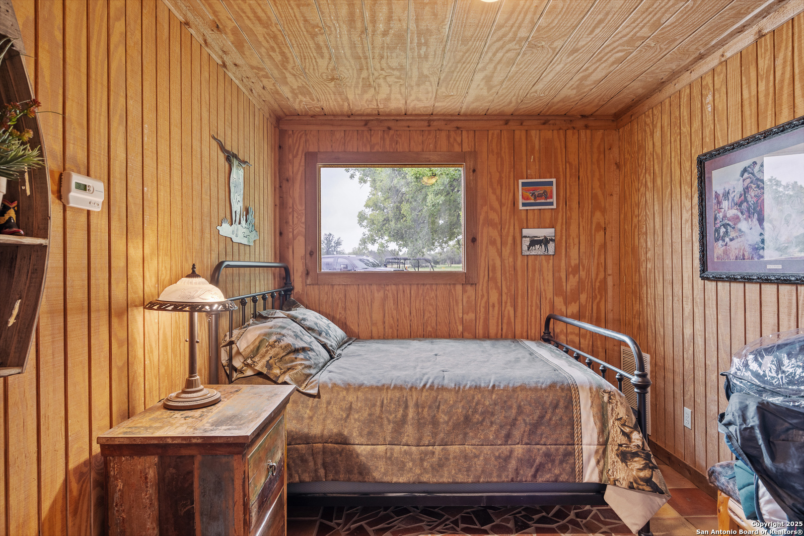 1897 Kyle Ranch Road Bandera, TX 78003 - Photo 10 of 48 a bedroom with a bed and wooden floor