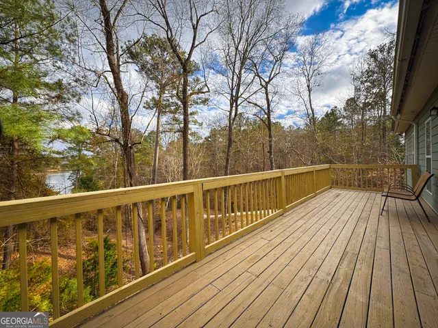 a view of balcony with wooden floor and fence