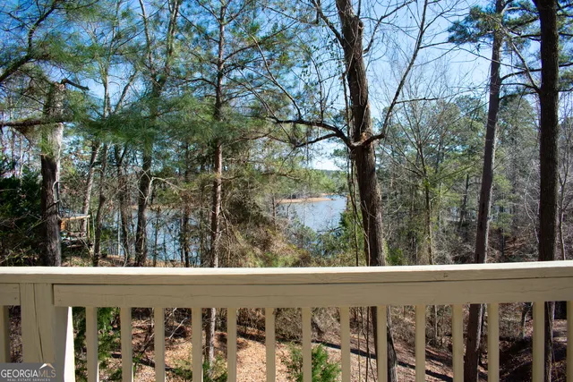 a view of a wooden fence and trees