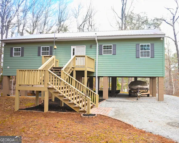 a view of a house with a patio and a yard