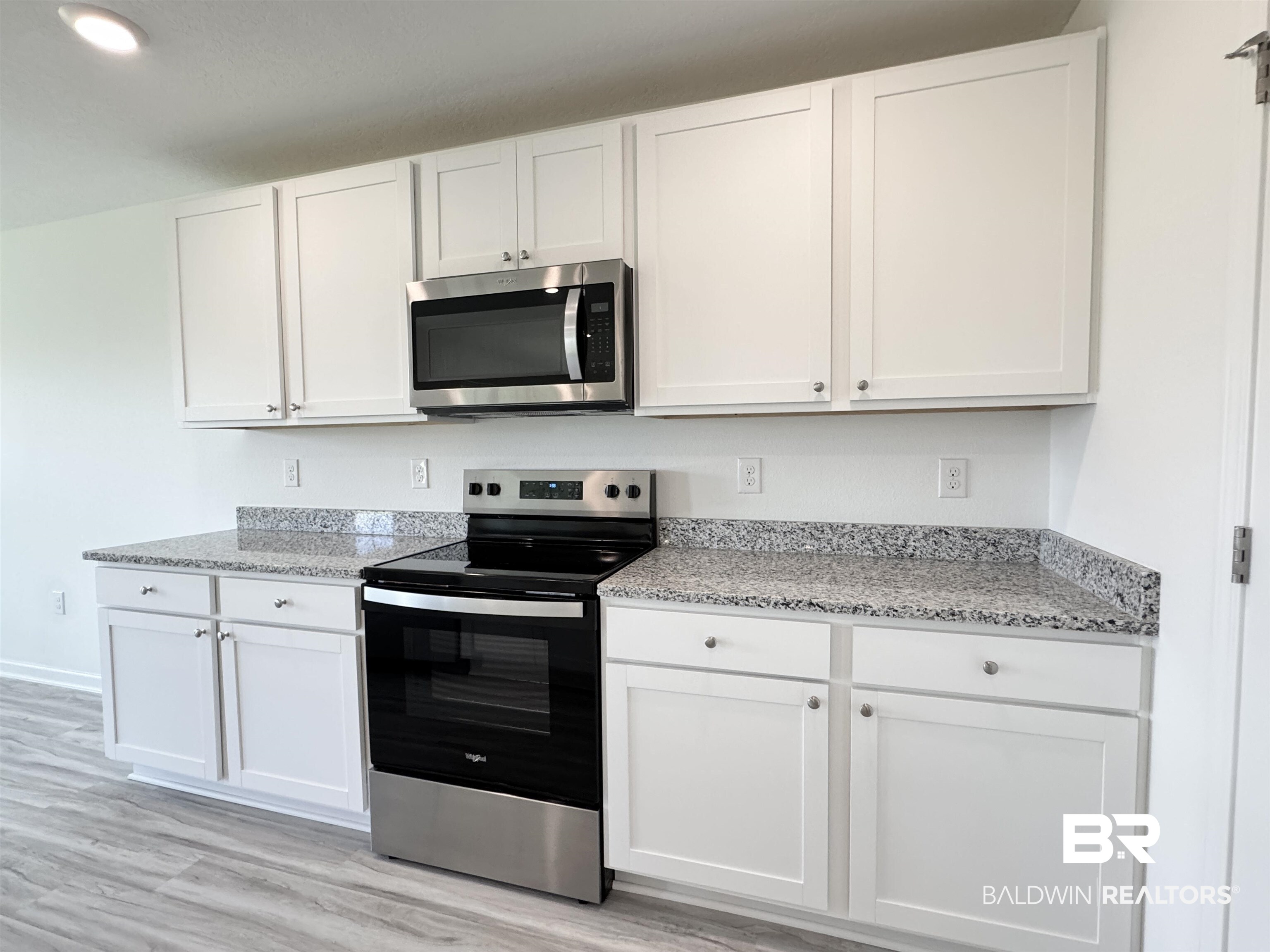 22072 Aleutian Avenue Foley, AL 36535 - Photo 34 of 47 Kitchen with stainless steel appliances and white cabinetry