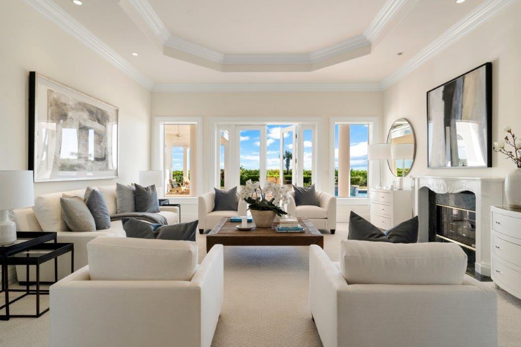 a living room with furniture white walls and a fireplace