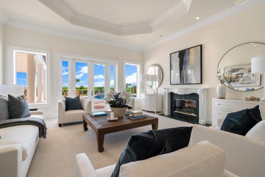 181 Ocean Beach Trail Vero Beach, FL 32963 - Photo 4 of 35 a living room with furniture a fireplace and a large window