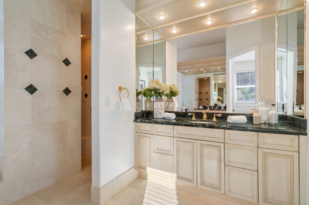 181 Ocean Beach Trail Vero Beach, FL 32963 - Photo 8 of 35 a bathroom with double sink and a mirror