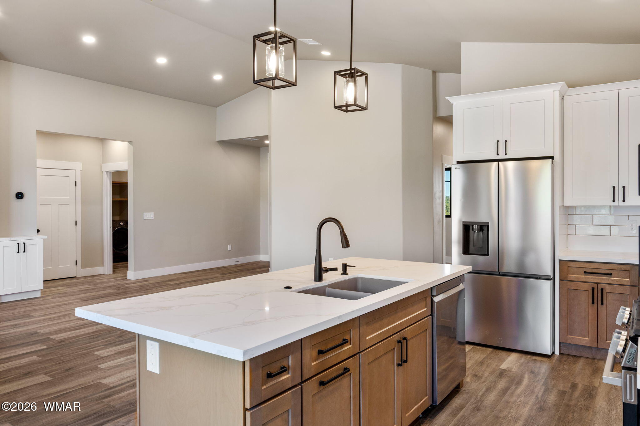 561 South Rock Ridge Drive Show Low, AZ 85901 - Photo 6 of 28 a kitchen with kitchen island stainless steel appliances a sink cabinets and wooden floor