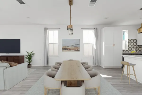 a large kitchen with a wooden floor and stainless steel appliances