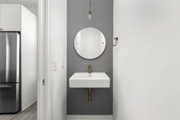 a view of empty room with wooden floor and window