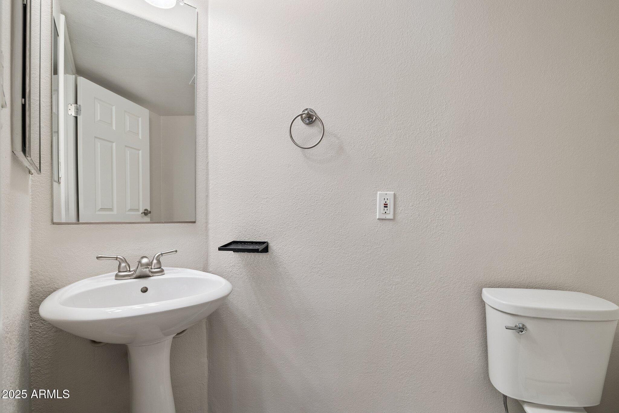 935 North Granite Reef Road, Unit 100 Scottsdale, AZ 85257 - Photo 11 of 35 a bathroom with a sink toilet and a mirror