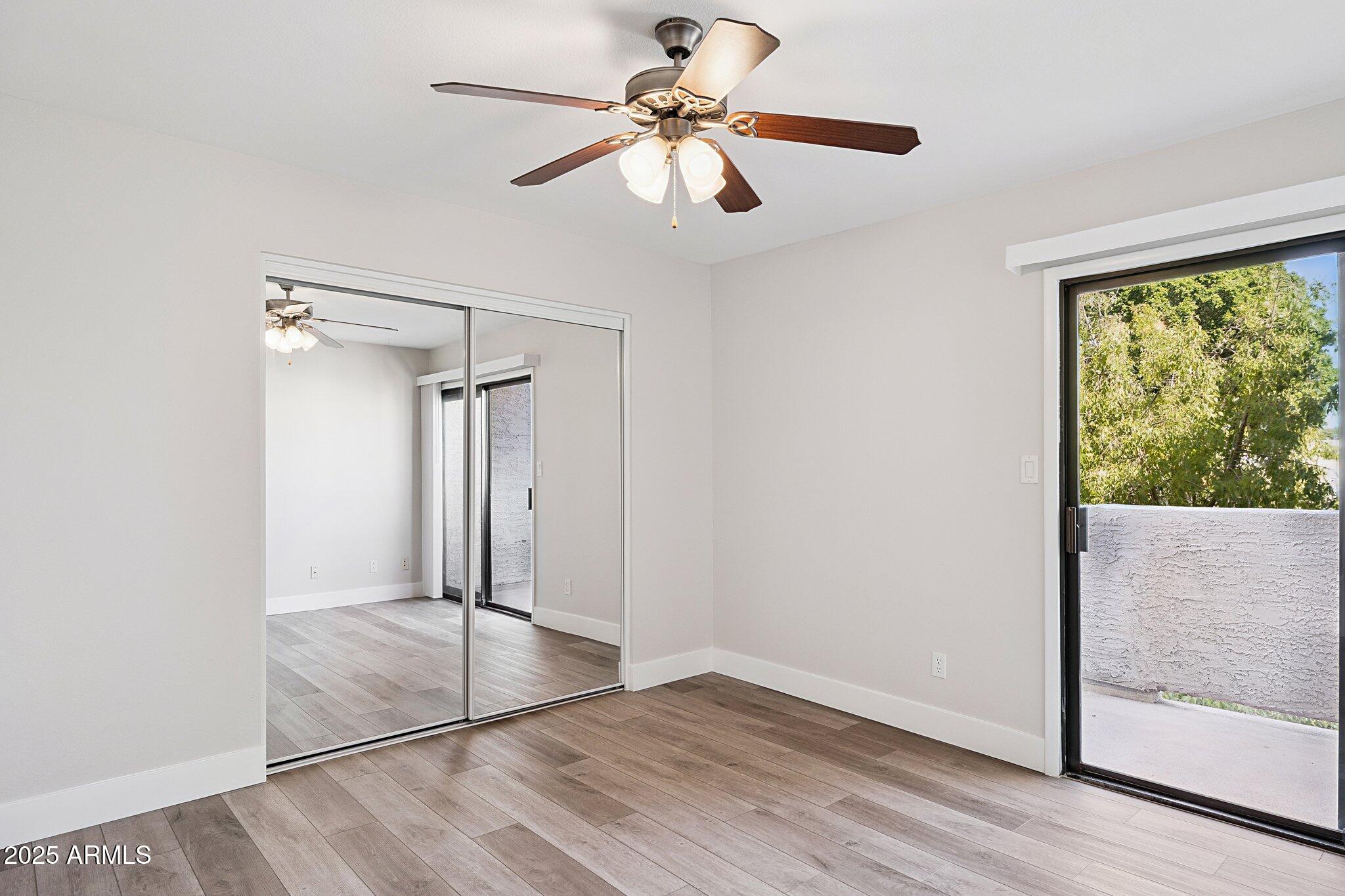 935 North Granite Reef Road, Unit 100 Scottsdale, AZ 85257 - Photo 14 of 35 an empty room with fan and windows
