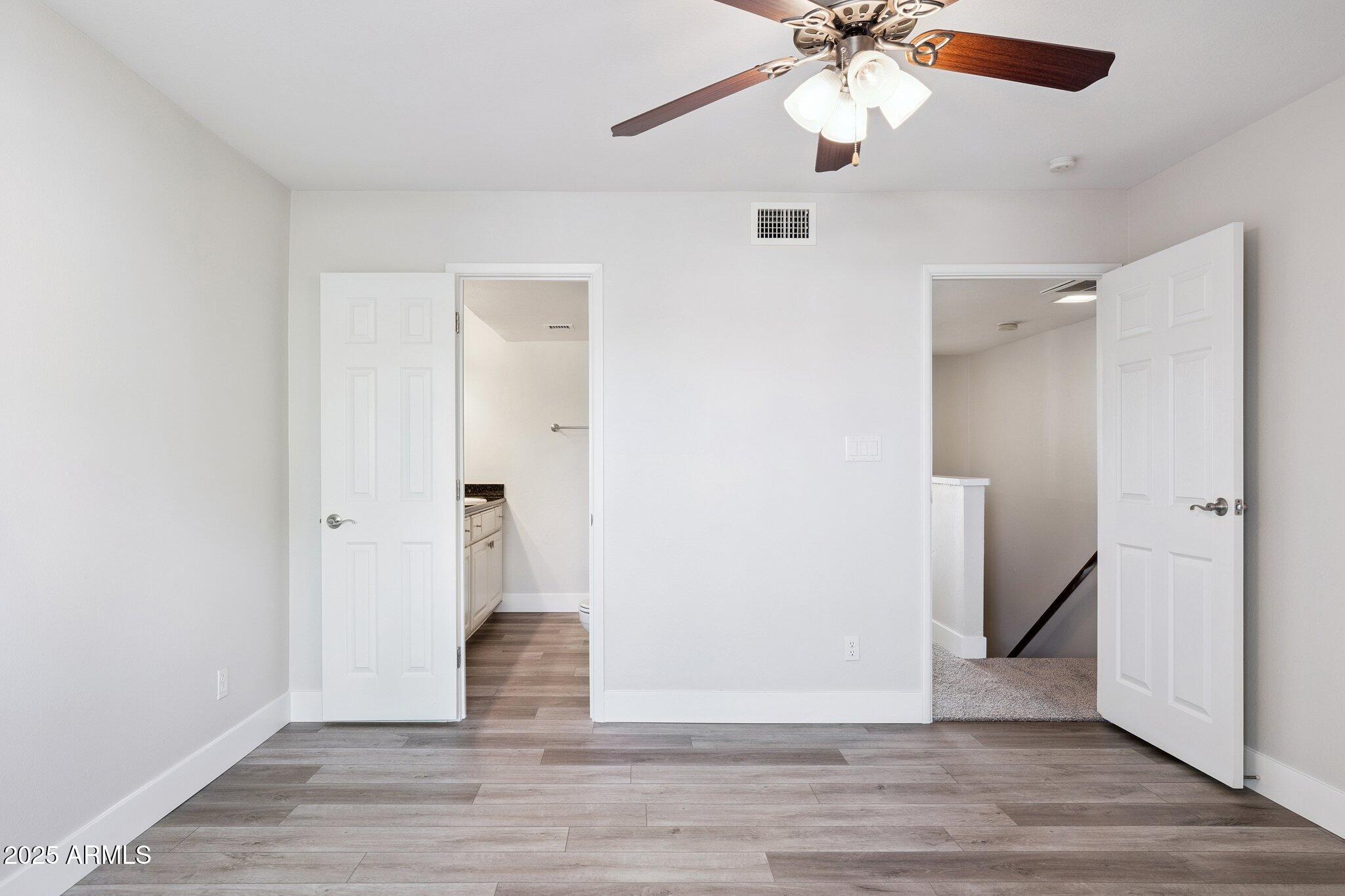 935 North Granite Reef Road, Unit 100 Scottsdale, AZ 85257 - Photo 15 of 35 an empty room with wooden floor and ceiling fan