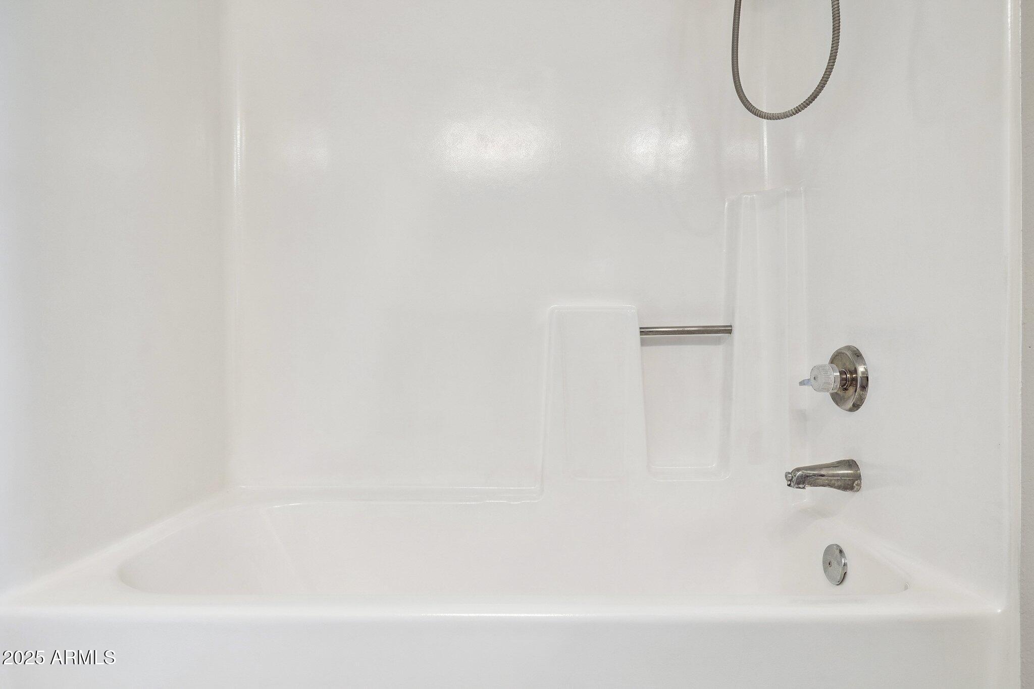 935 North Granite Reef Road, Unit 100 Scottsdale, AZ 85257 - Photo 17 of 35 a bathroom with a bath tub with a shower