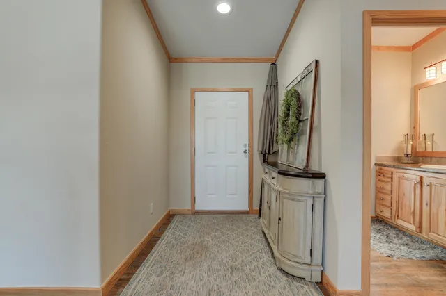 a kitchen with stainless steel appliances granite countertop a sink a stove and a wooden floors