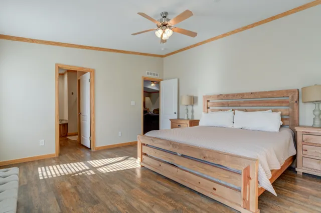 a bedroom with a bed and a chandelier