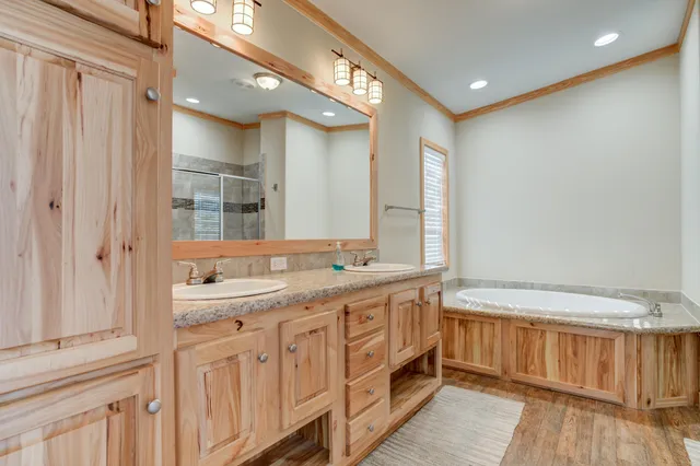 a bathroom with a double vanity sink and a mirror