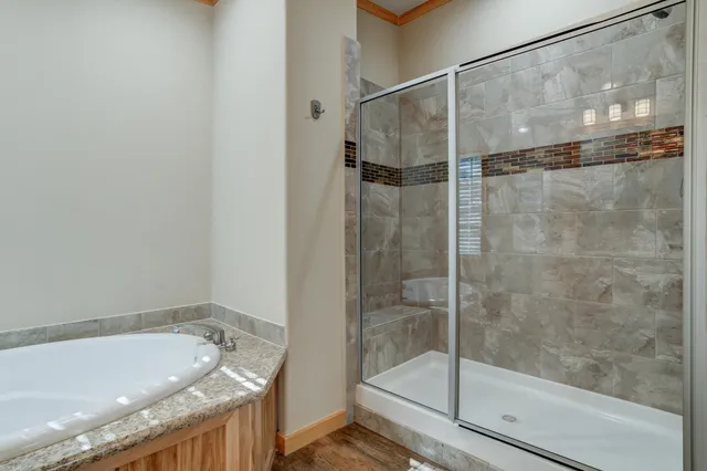 a bathroom with a granite countertop toilet sink and mirror