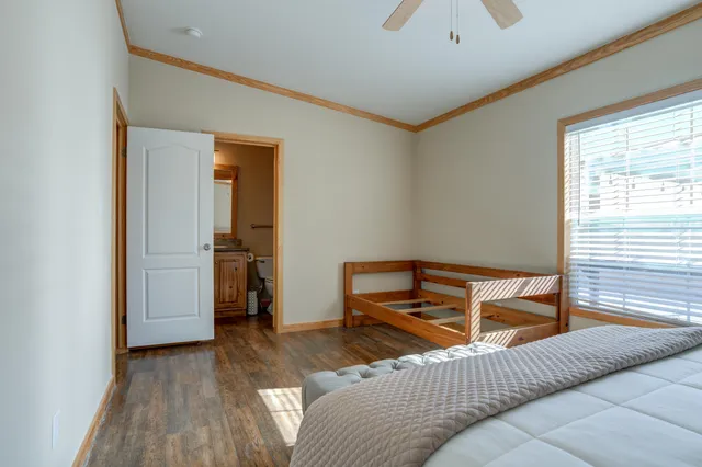 a view of a patio with table and chairs under an umbrella with wooden floor