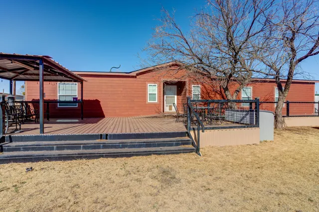 a bedroom with bed and wooden floor