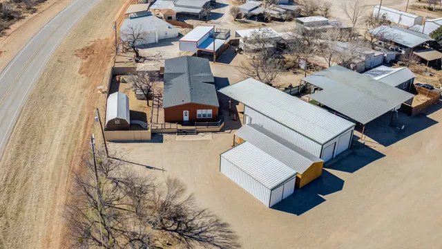 an aerial view of a house with a large tree