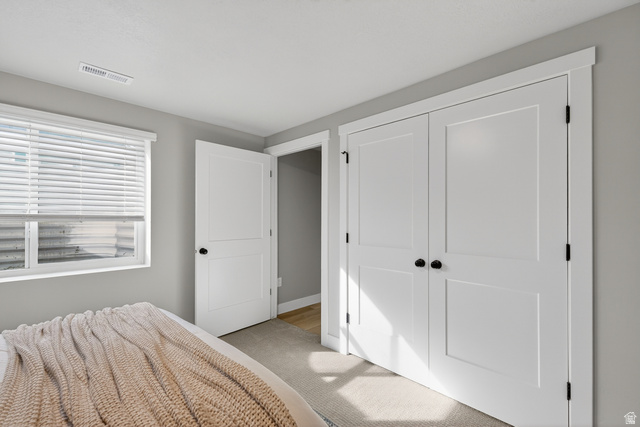 2841 West 2705 North, Unit 69 Ogden, UT 84404 - Photo 28 of 31 Bedroom featuring a window with blinds, light gray walls, and carpet flooring