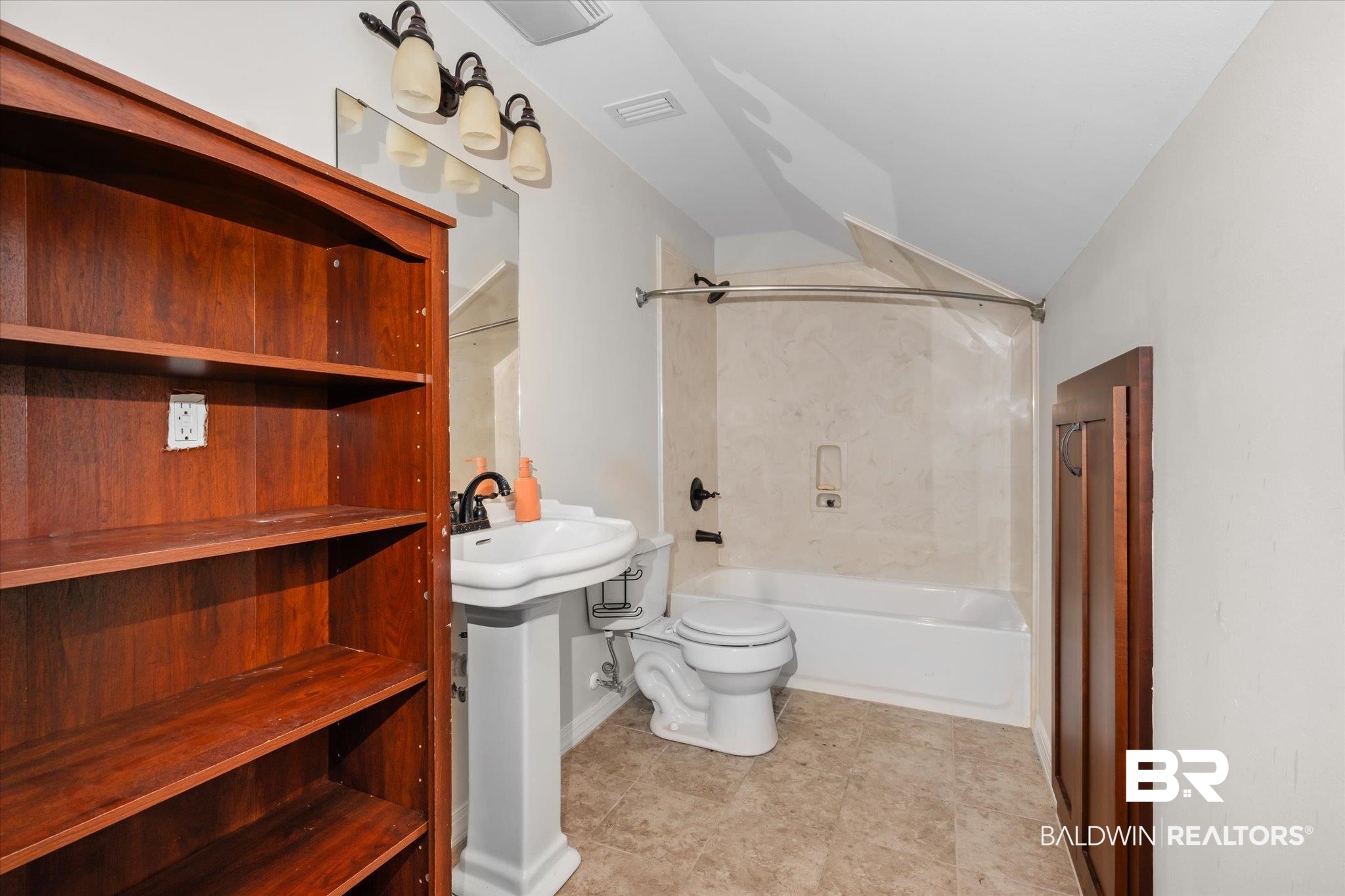 20792 Lonnie Walker Road Citronelle, AL 36522 - Photo 16 of 19 Bathroom with vaulted ceiling, shower / bathtub combination, and toilet